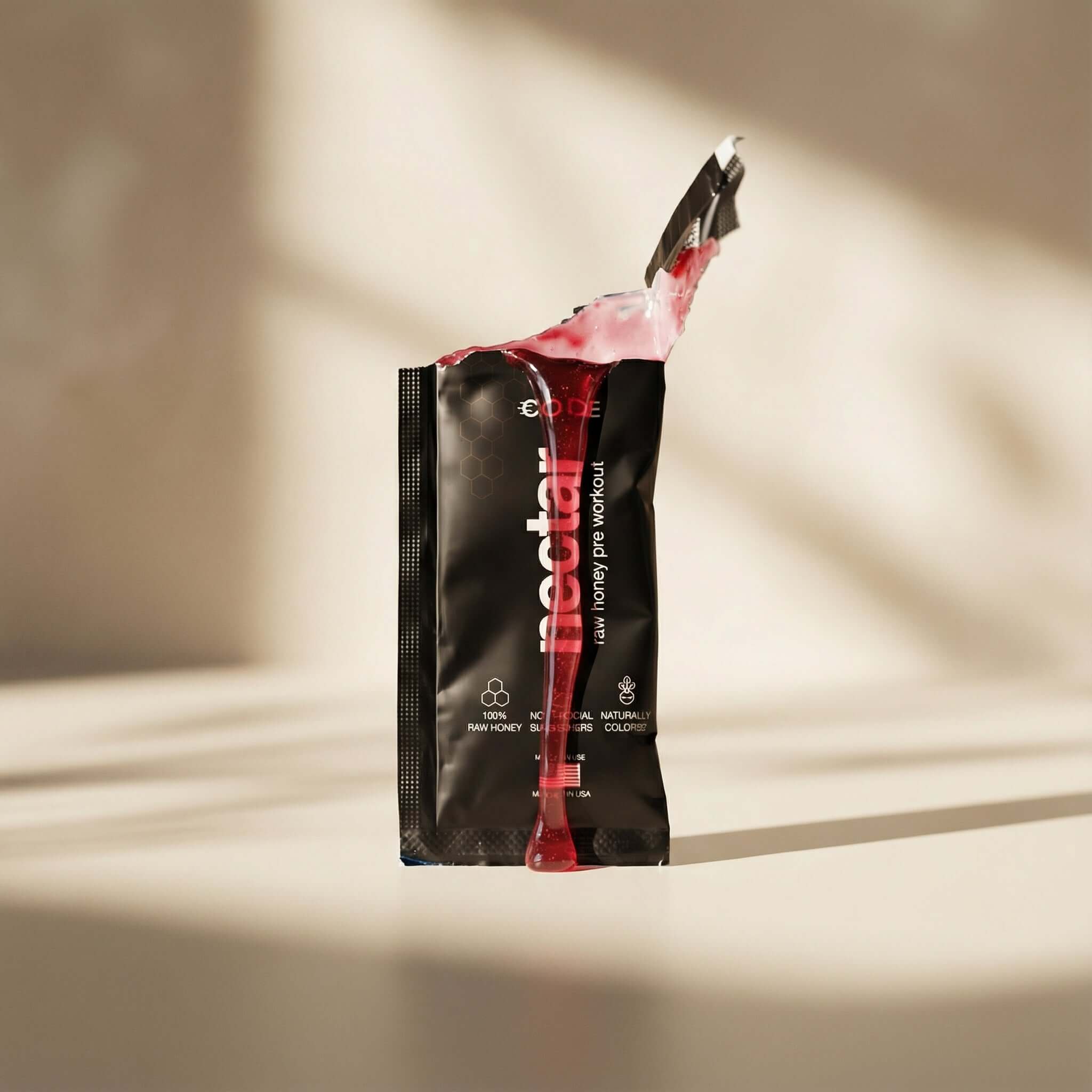 Black and red package of Nectar on a beige background